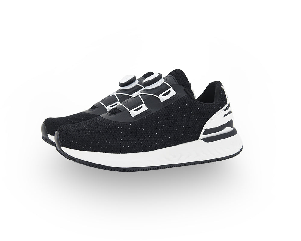 Black and white indoor cycling shoe on a white background